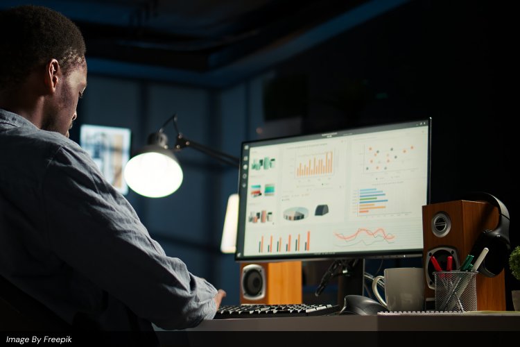 Digital marketing professional at Ayanex analyzing website speed and SEO metrics using data analytics overlays.