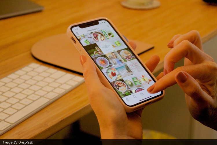 Hands holding a smartphone and scrolling through an Instagram feed filled with vibrant food and lifestyle photos, symbolizing Instagram content creation, user engagement, Reels strategy, and advanced growth techniques for businesses.